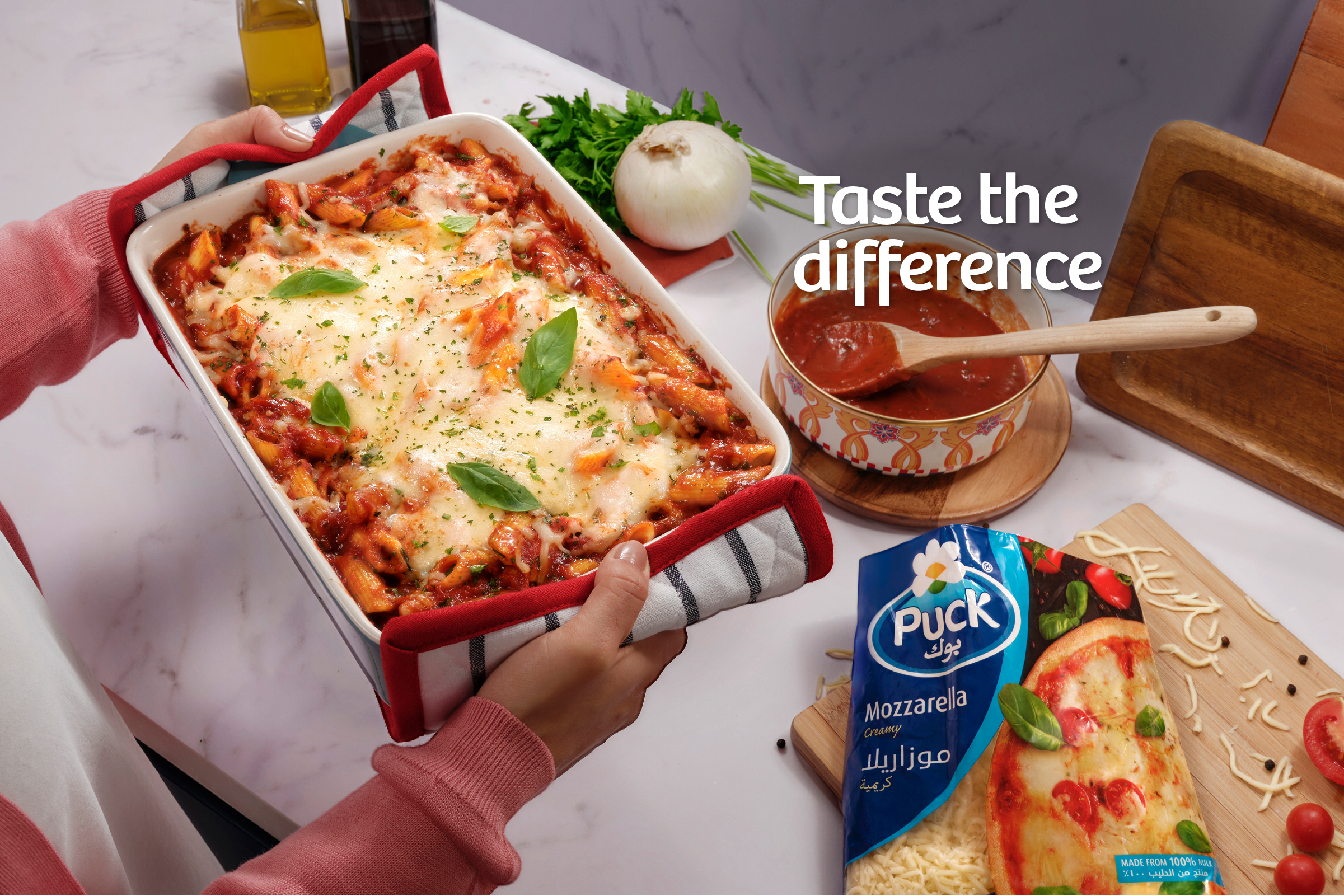 Cheesy baked penne pasta with Puck shredded creamy mozzarella cheese