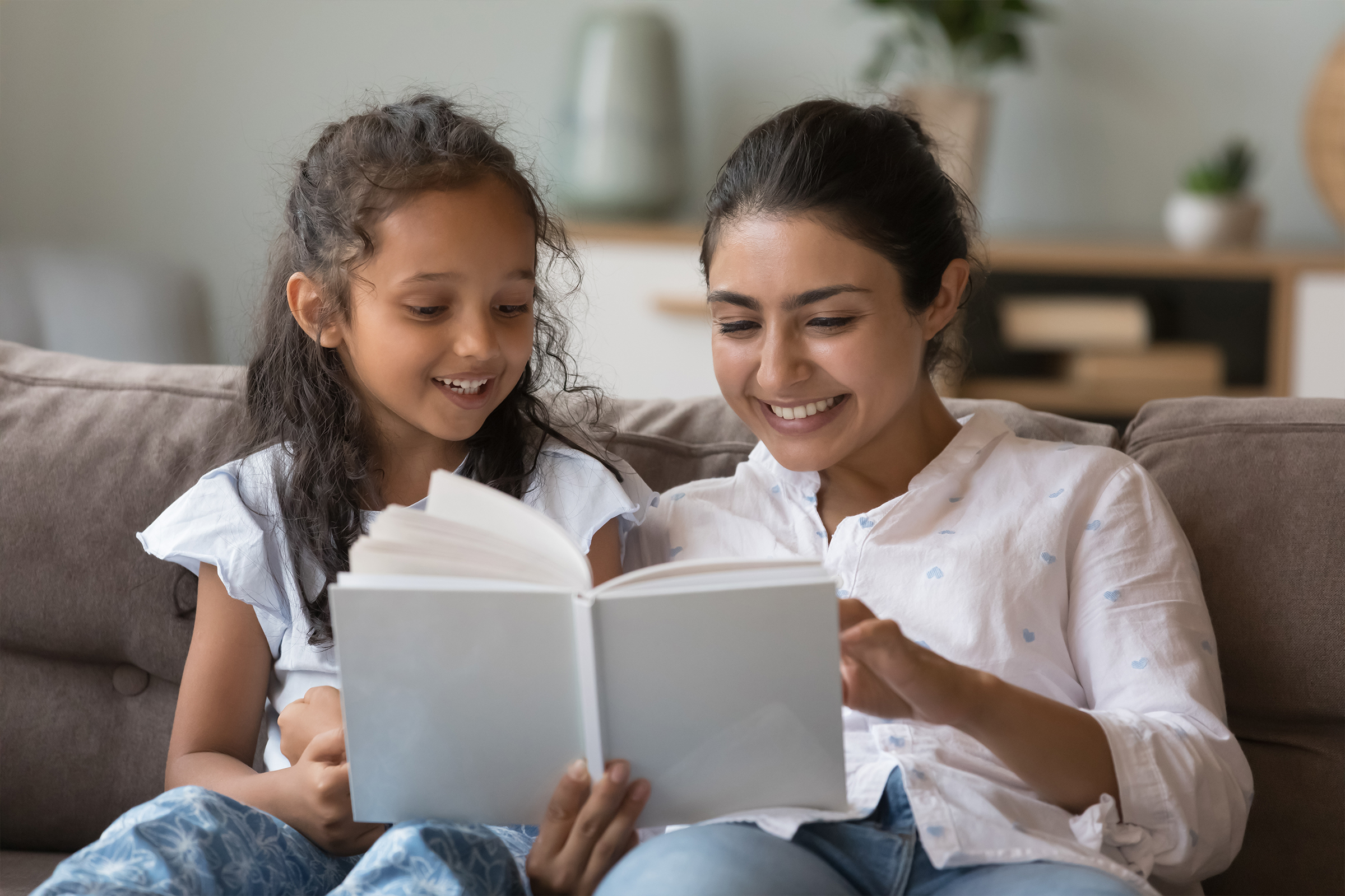 Mother and daughter reading together at home