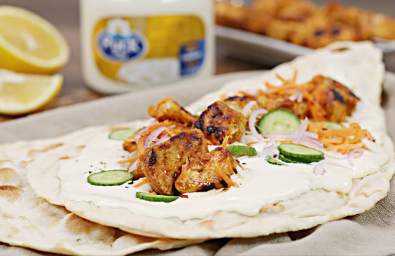 Naan bread sandwich with cheese, tikka chicken and vegetables